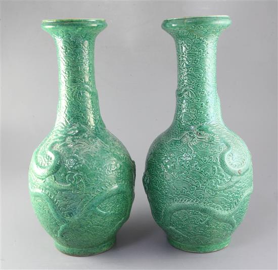 A pair of Chinese green glazed dragon vases, late 19th/early 20th century, height 44.5cm, one neck repaired